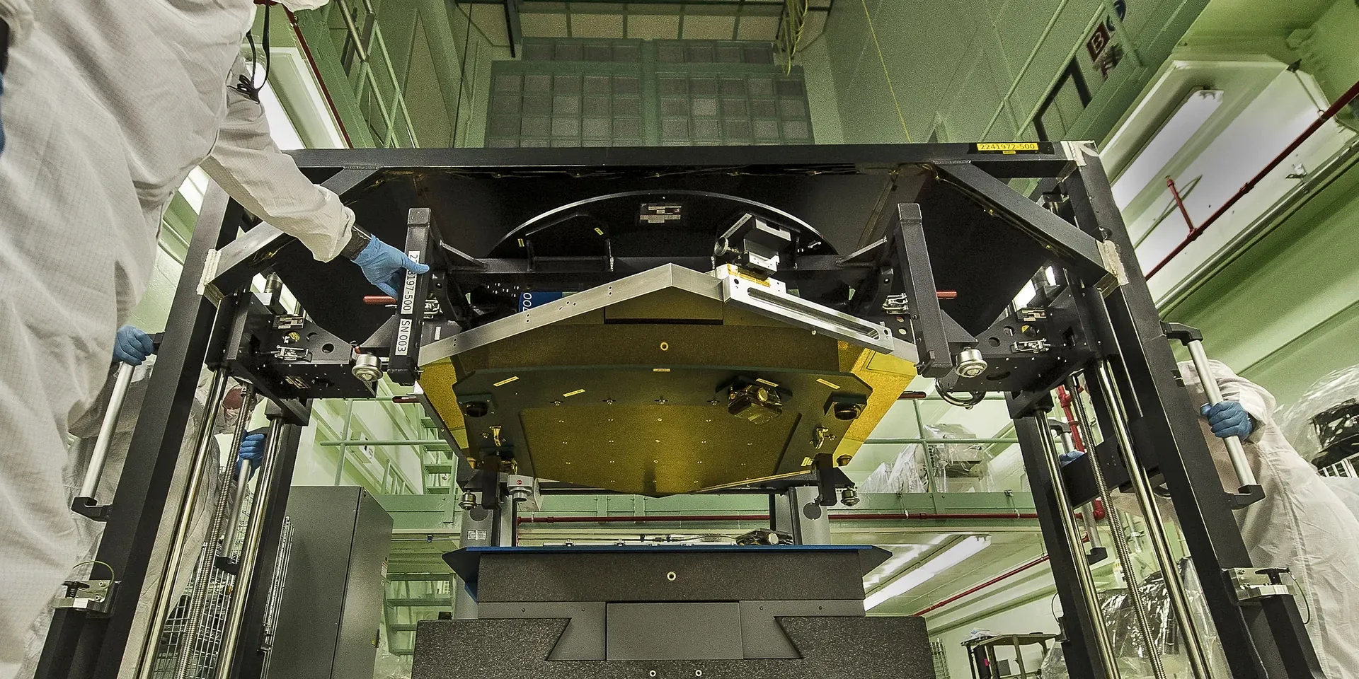 A gold Webb mirror segment held in a measurement fixture at NASA Goddard.